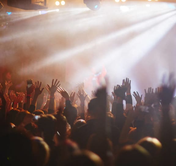 a crowd of people at a concert with their hands in the air at The Depot Luxury Apartment Homes, Raymore, MO