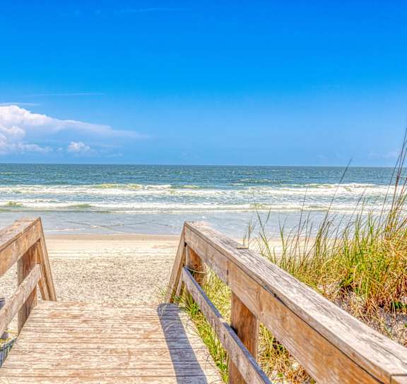 a pier in the ocean at sunset at AVIA Lofts on Liberty Ridge, Jacksonville, FL, 32256