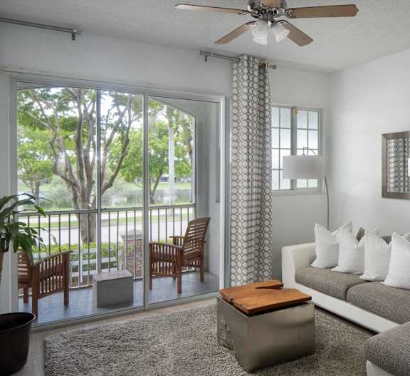 A modern living room with a grey couch, a coffee table, and a large abstract painting on the wall.