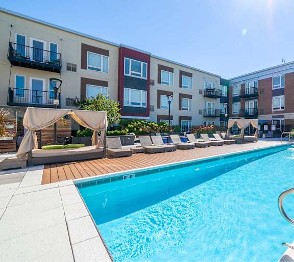 A swimming pool in front of apartment buildings.