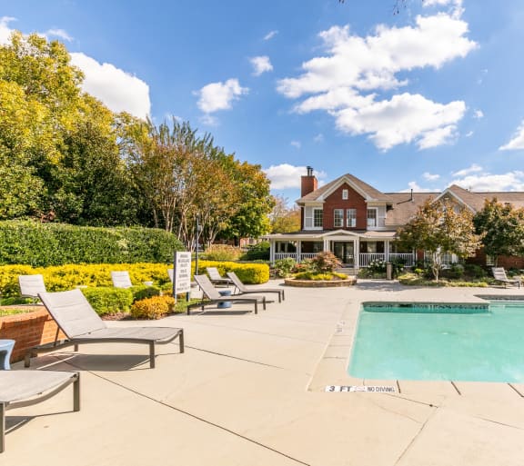 a swimming pool with a house in the background at Roswell Village in Georgia 30075