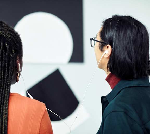 two women wearing headphones talking to each other at Anthem at Square 10 in New Haven, CT 06511