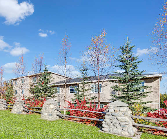 The exterior of Amber Ridge with fences, trees, and green spaces. 