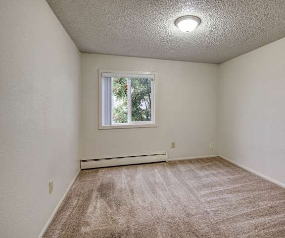Empty bedroom at Arctic Sun Apartments.