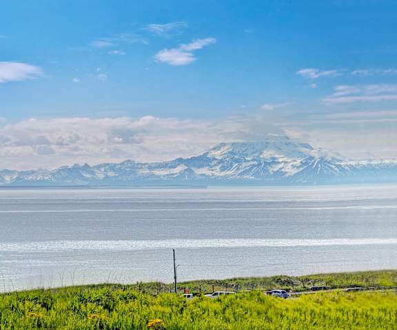 A view of the ocean with mountains in the background at Bay Arms Apartments. 
