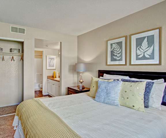 A bedroom with a queen-sized bed and a closet at Castlepark Apartments