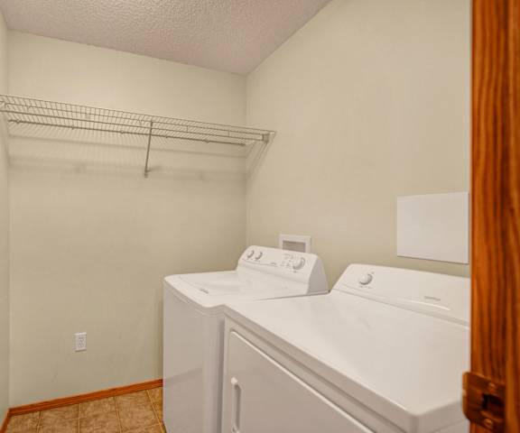The laundry room with a washer and dryer at Birch Terrace. 