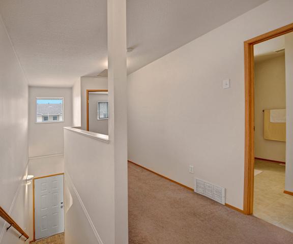 A hallway showing the doorframes of multiple rooms and a stairwell at Carrington Place. 