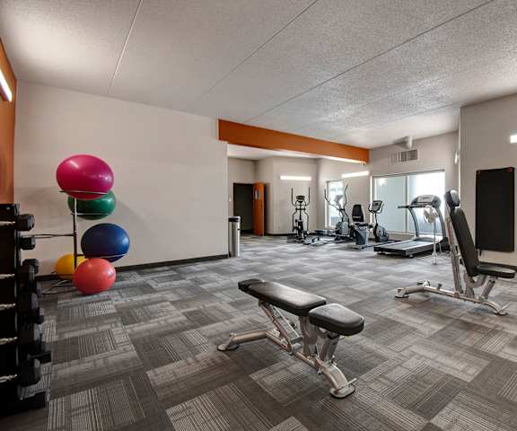 The gym with cardio machines and weights at Centre Pointe Plaza. 
