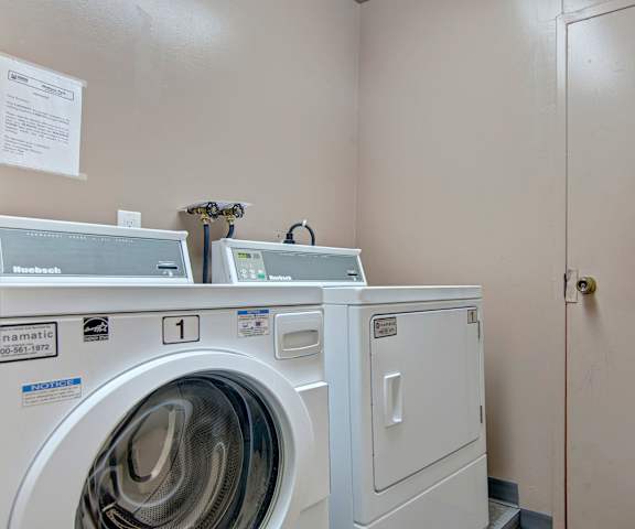 The laundry room with washers and dryers at Madison Park Apartments. 