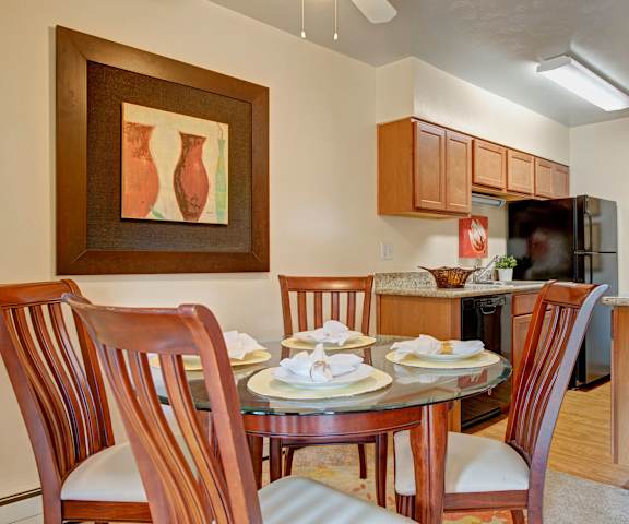 The dining room with a dining table and chairs and a view of the kitchen at Copper Stone. 