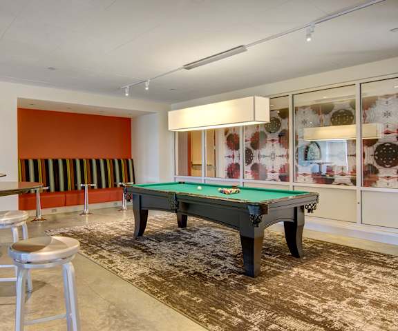 Resident game room with a pool table and bar tables surrounding at 7West. 