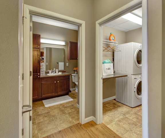 Dakota Commons In-unit Laundry A view of the bathroom and the laundry room at Dakota Commons Apartments.