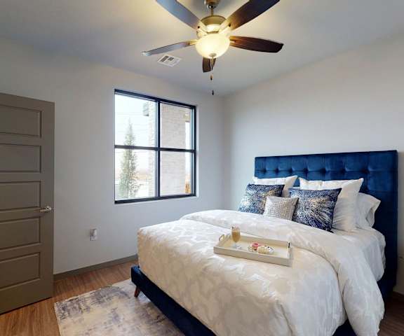 A bedroom at 35 Degrees with a bed, window, and doorway. 