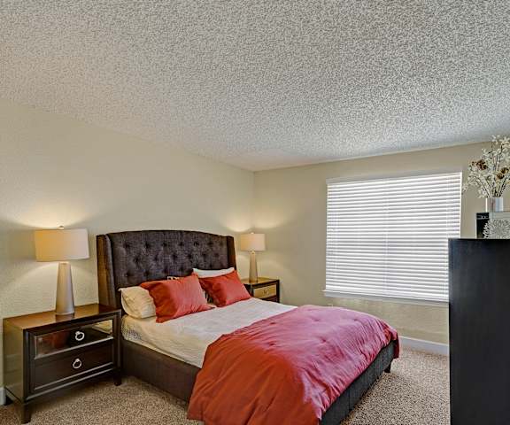 A bedroom with a bed and a dresser and a window at Acacia Park. 