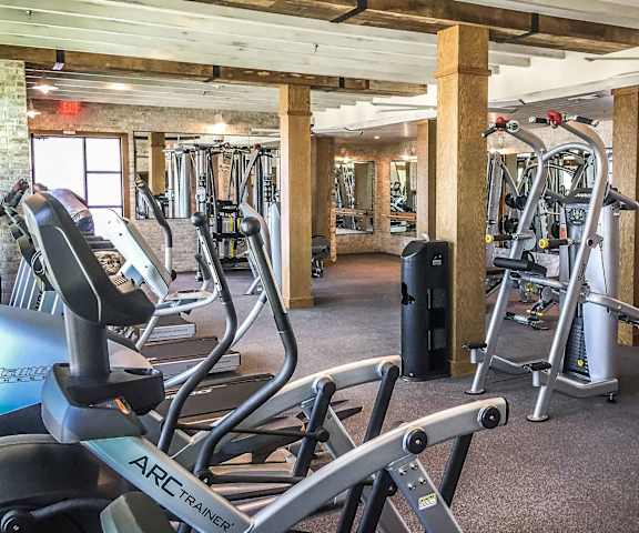 The Crosby at The Brickyard fitness center A spacious gym with cardio machines, windows, TVs, and weights at the Crosby at the Brickyard Apartment Homes.