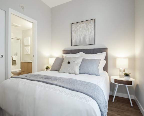 a bedroom with a bed and a door to a bathroom