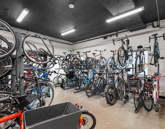 a bunch of bikes are hanging up in a bike shop