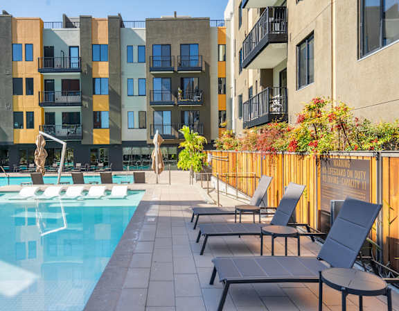 Pool with white sun loungers at Misora Apartments, San Jose, California