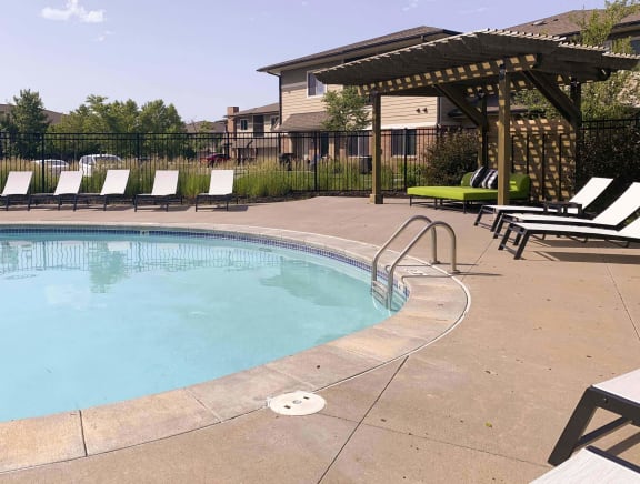 Resort style swimming pool with sun tanning loungers at North Pointe  Villas Lincoln Nebraska