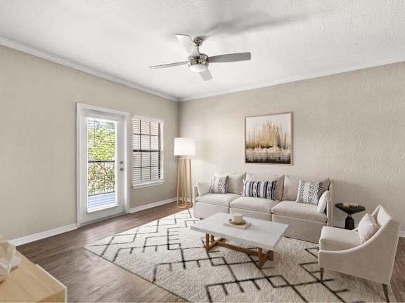 A living room with a white couch and a rug.