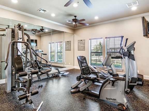 A gym with treadmills, elliptical machines, and other cardio equipment.