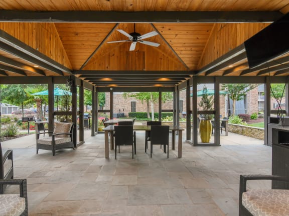 a porch with a ceiling fan and a couch at Ashford Place Apartment Homes, Flowood, MS 39232
