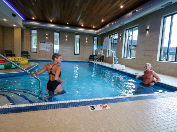 a man and a woman in a swimming pool at Bluestone Flats, Duluth, 55803
