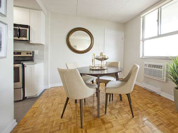 a dining room with a table and chairs and a kitchen
