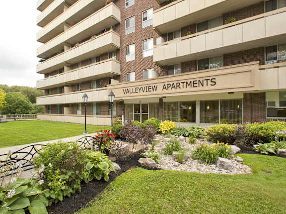 a garden in front of an apartment building