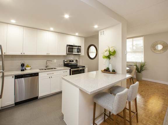a kitchen with white cabinets and a white counter top