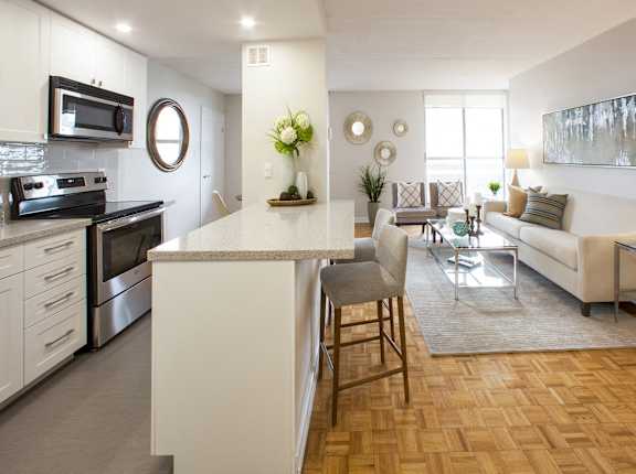 a living room with a kitchen and a dining room