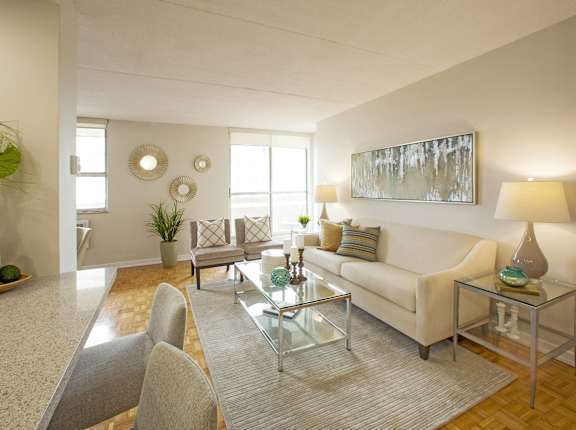 a living room with a white couch and a glass table