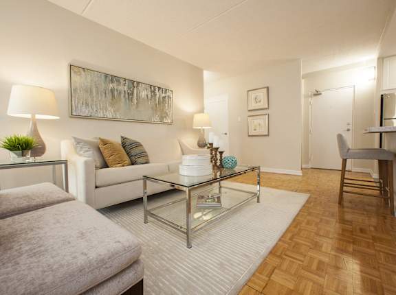 a living room with a couch and a glass coffee table