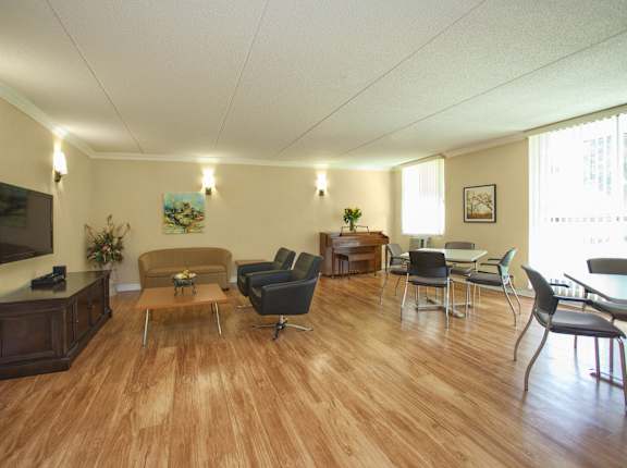a living room with couches and chairs and a television