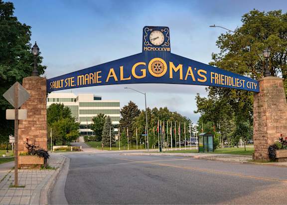 The entrance to Algoma's Friendliest City is marked by a large archway sign.