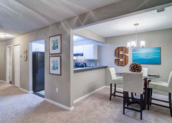 A dining room with a table set for four.