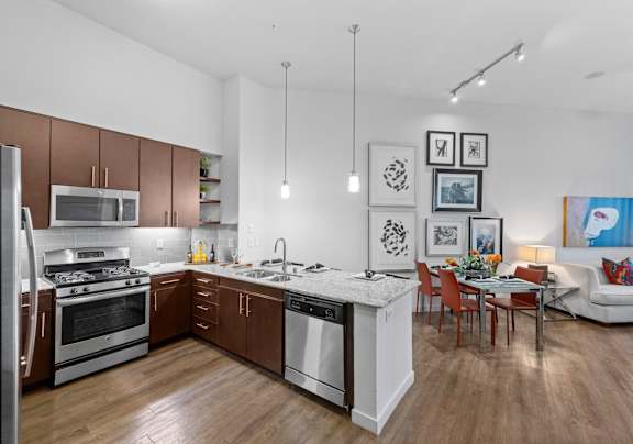 A modern kitchen with white cabinets and a black stove top.