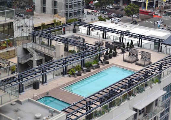 A large pool surrounded by balconies and railings.