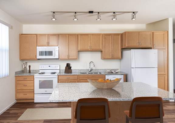a kitchen with white appliances and wooden cabinets
