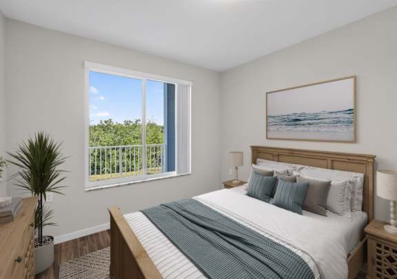 A bedroom with a large bed and a painting of a beach scene on the wall.