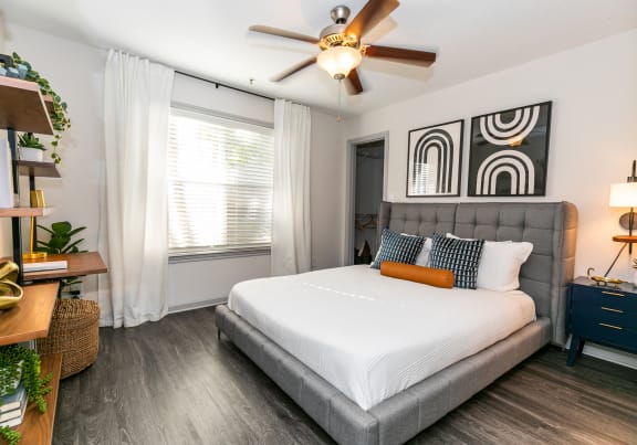 a bedroom with a bed and a geometric wallpaper on the wall at Briarcliff Apartments in North Druid Hills, Georgia