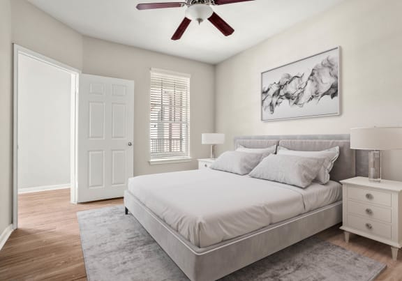 a bedroom with a bed and a geometric wallpaper on the wall at Veranda at Centerfield in Houston, Texas 77070