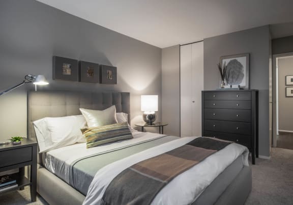 a bedroom with a bed and a geometric wallpaper on the wall at The Montrose in Chicago, Illinois 60613