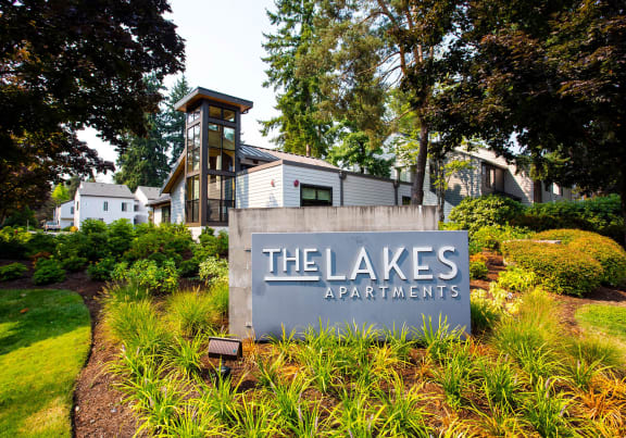 a large building with a pond in front of it at The Lakes Apartments, Bellevue, 98007