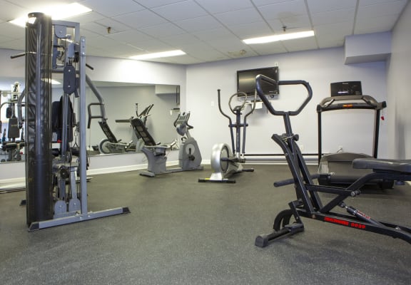 a gym with cardio machines and other equipment in a building