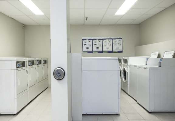 an empty laundry room with washer and dryer machines