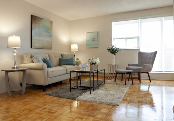 a living room with a couch and chairs and a table