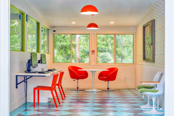 an office with red chairs and a table with a computer  at Rancho Los Feliz, Los Angeles, 90039