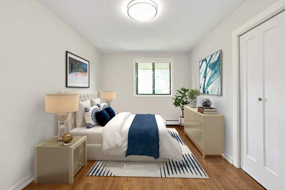 A bedroom with a bed, nightstands, and a painting on the wall.